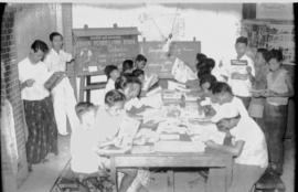 Suasana pengunjung Taman Bacaan Japen Kec. Nganjuk: Para pengunjung sedang memperhatikan foto-fot...